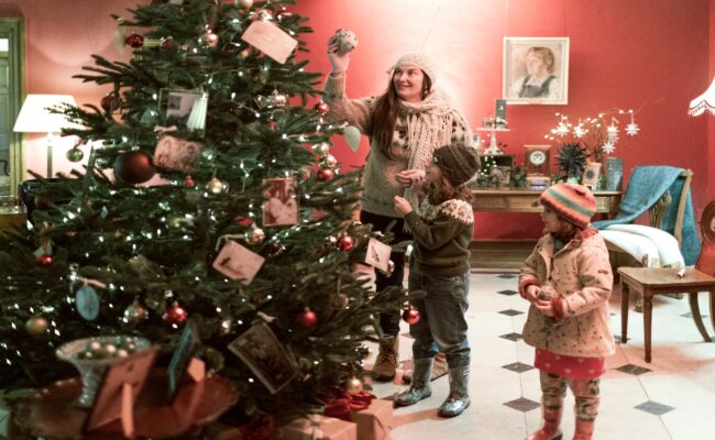 Children looking at a Christmas tree at Killerton