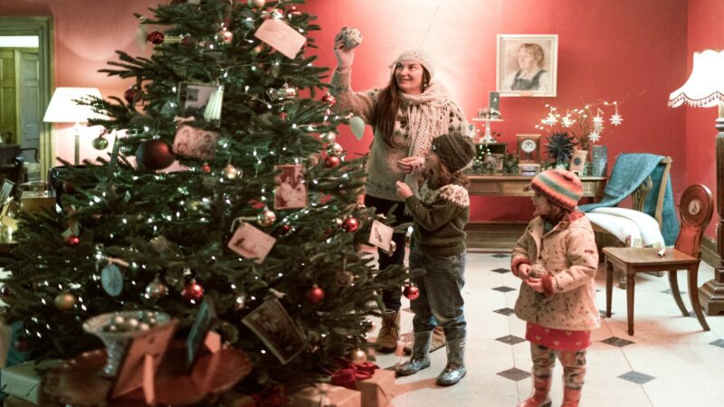 Children looking at a Christmas tree at Killerton
