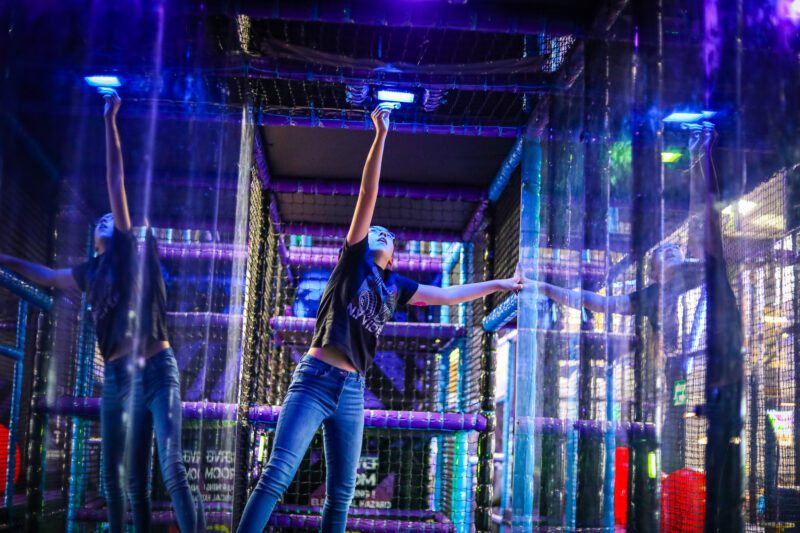 Teen playing in the Ninja Stars arena at The Milky Way Adventure Park in North Devon – fast-paced indoor activity with light-up targets