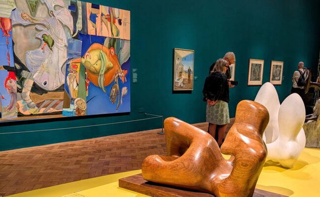 Photograph showing visitors looking at sculpture in an exhibition