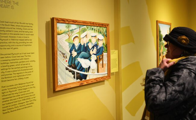A visitor looking at 'Sailors and Seagulls' by Beryl Cook on display at The Box in Plymouth