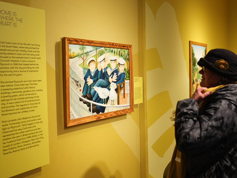 A visitor looking at 'Sailors and Seagulls' by Beryl Cook on display at The Box in Plymouth