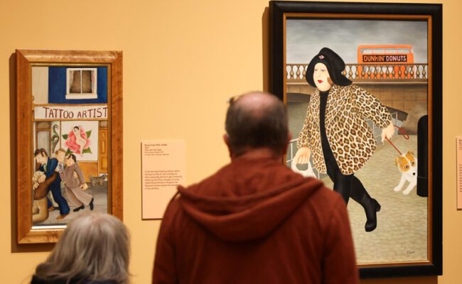 Visitors look at paintings by Beryl Cook on display at The Box in Plymouth