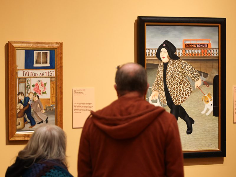 Visitors look at paintings by Beryl Cook on display at The Box in Plymouth