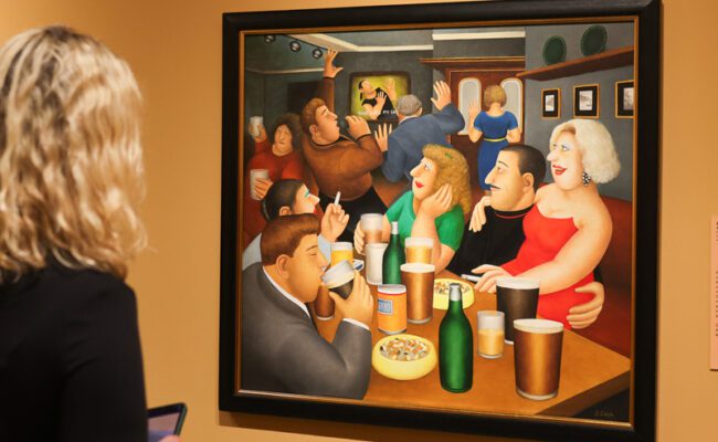 A visitor looking at 'Karaoke' by Beryl Cook on display at The Box in Plymouth