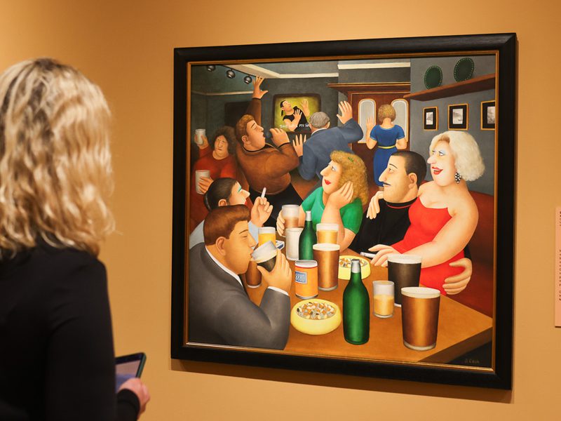 A visitor looking at 'Karaoke' by Beryl Cook on display at The Box in Plymouth