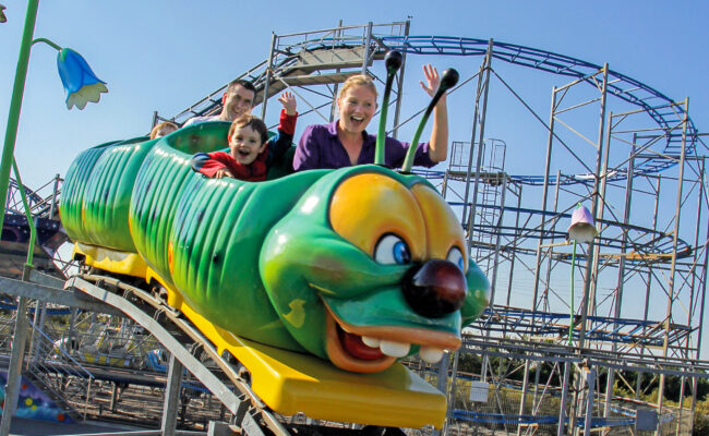 Young family riding the Caterpillar Coaster at The Milky Way Adventure Park in North Devon – perfect for younger children and family fun