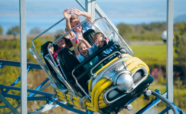 Families riding the Cosmic Typhoon rollercoaster at The Milky Way Adventure Park in North Devon – outdoor fun with views of the coast