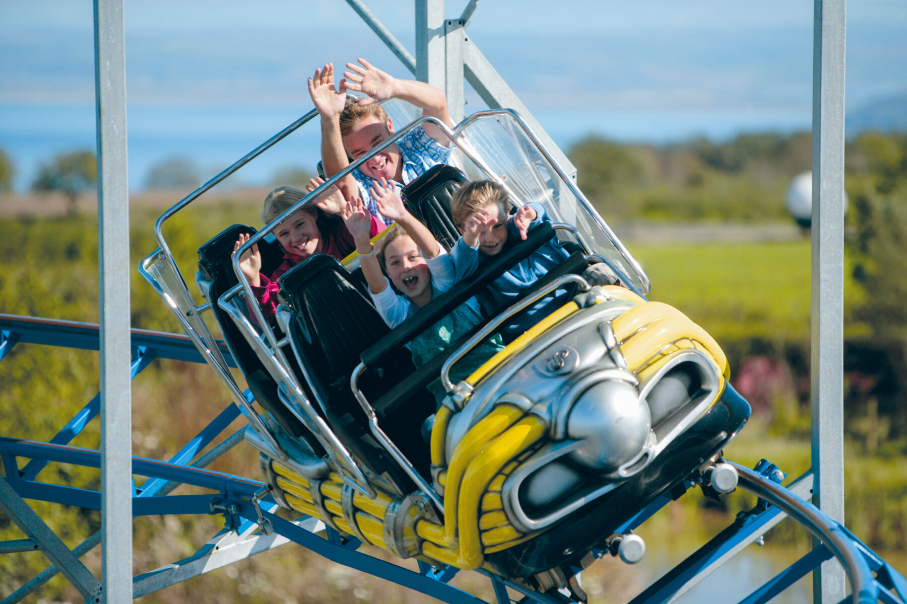 Families riding the Cosmic Typhoon rollercoaster at The Milky Way Adventure Park in North Devon – outdoor fun with views of the coast