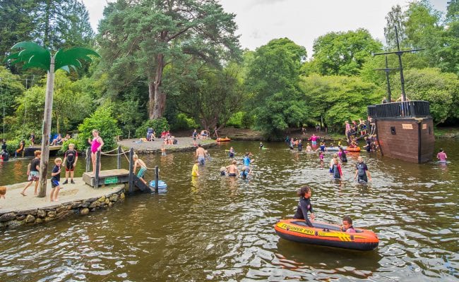 Children playing on the ships and in the water at River Dart