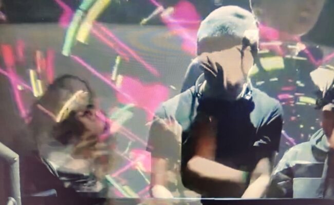 People DJing with abstract lighting and reflections