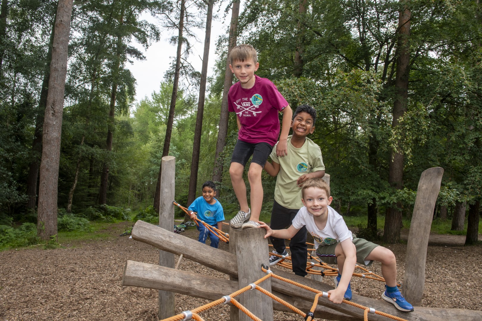 Children playing on a wooden play structure