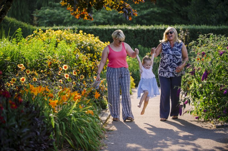 A family walk through the Hot Garden at a Summer Late Event at RHS Garden Rosemoor.
