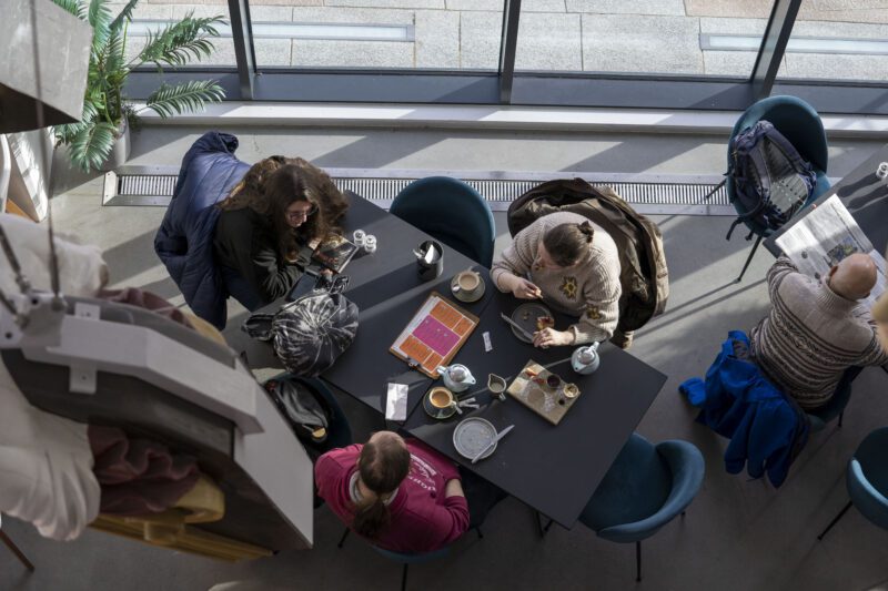 A high view of people sat around a table in a cafe