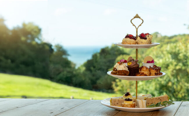 three tiered cake stand in fron of seaside view