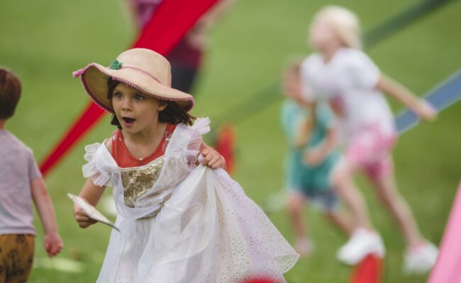 Child in dressing up outfit playing at Killerton