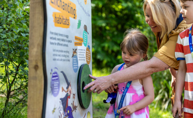 A family enjoying the Room on the Broom activity trail