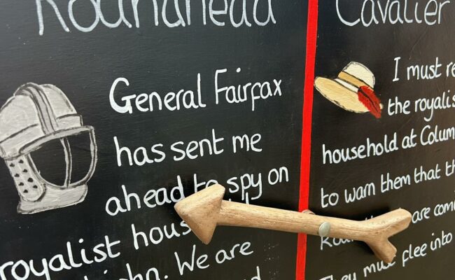 A blackboar showing a game for May half term at Killerton
