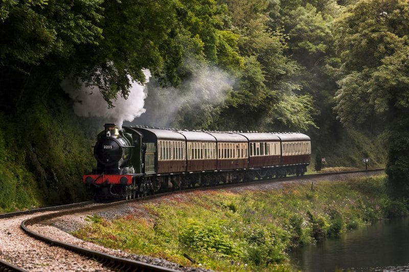 Train travelling on track on South Devon Railway 