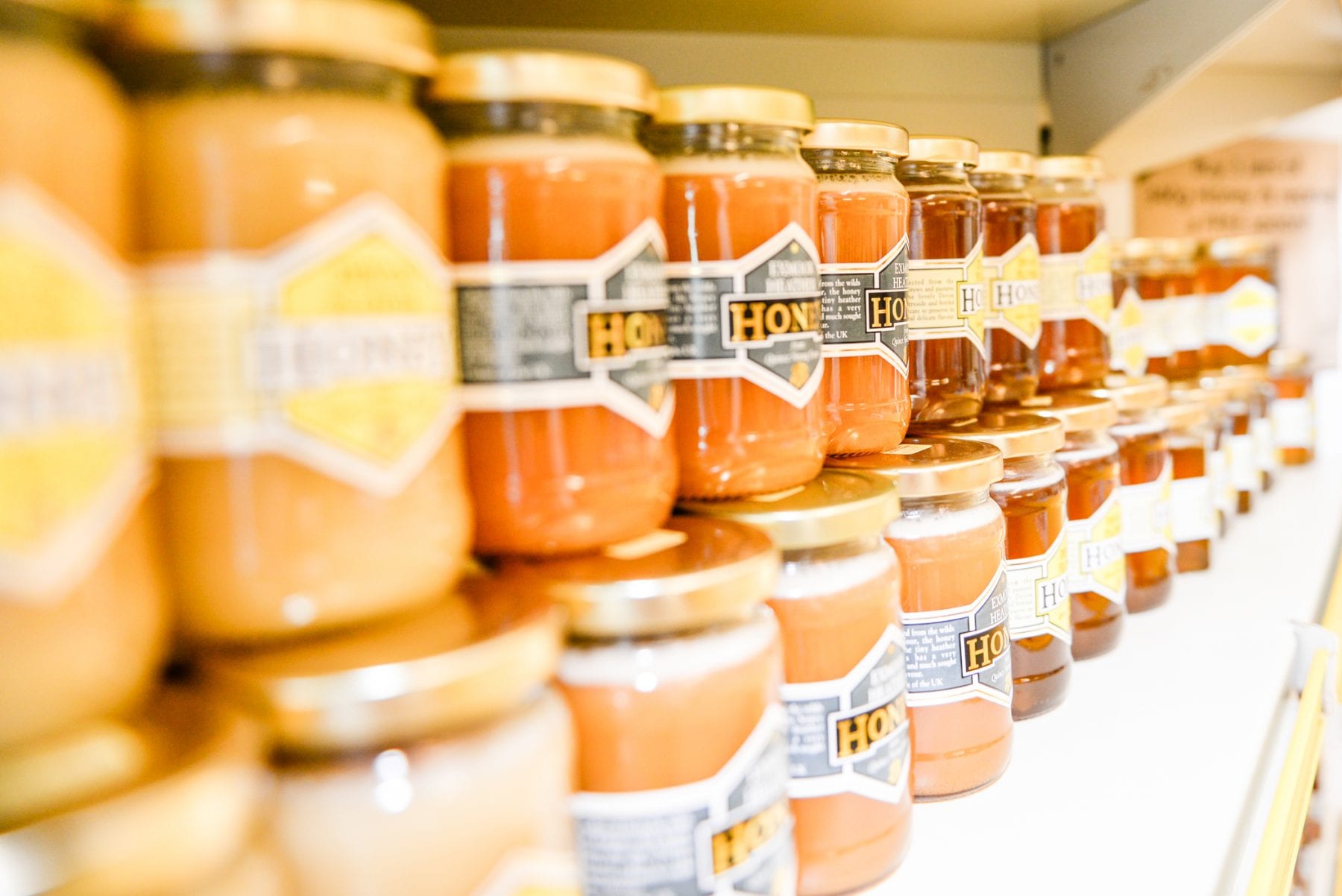 Pots of locally made honey, stacked on a shelf