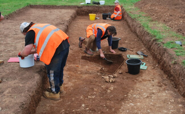 Students digging in an archaeology trench at Killerton