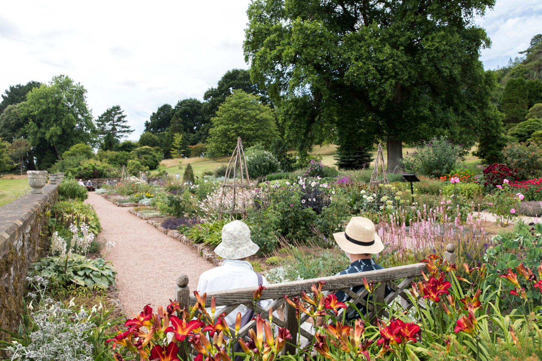 Visitors sat on a bench in the garden