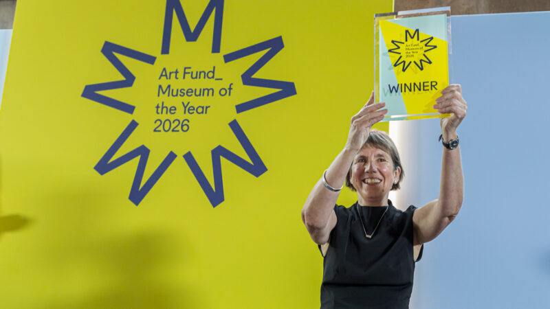 Victoria Pomery, CEO of The Box holds the winners plaque above her head
