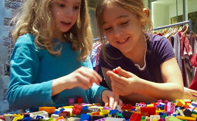 Two children playing with LEGO