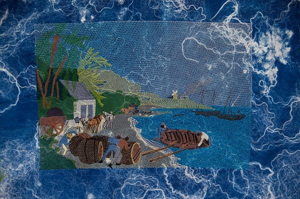 Blue, sea-like textile with embroidery of a beach scene in response to the exhibition 'In Plain Sight'