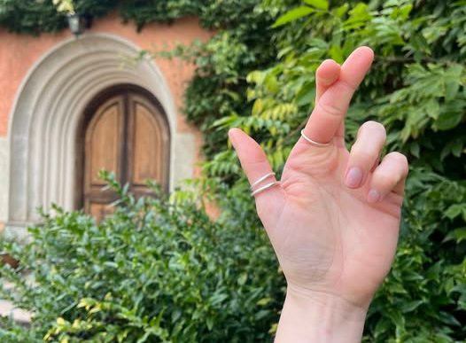A woman's hand crossing her fingers like the National Lottery logo