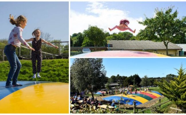 children jumping on large trampoline pillows